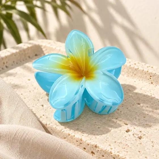 Blue frangipani hair claw · Yellow center · Product image