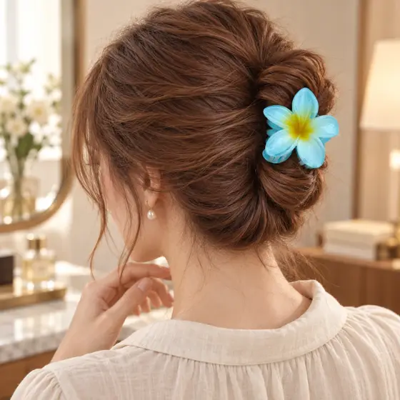 Blue frangipani hair claw · Yellow center · Updo rear view