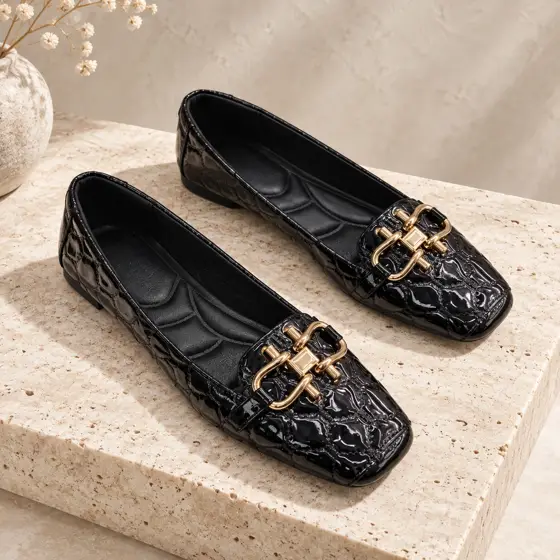 Black buckle flats · Product still life